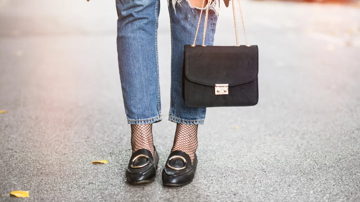 Woman wearing jeans and black loafers